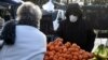 A man wearing a protective mask shops in the market of Crepy-in-Valois on March 1, 2020, before its evacuation following the outbreak of COVID-19. 