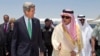 U.S. Secretary of State John Kerry, left, is greeted by Saudi Foreign Minister Prince Saud al-Faisal upon arrival in Jeddah, Saudi Arabia, June 25, 2013.