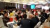 FILE - Local businessmen and foreign investors negotiate at a cross-border investment and trade fair in Guiyang, Guizhou Province, China, Nov. 10, 2016. 