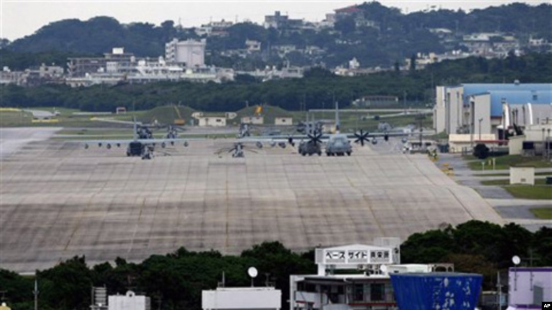 U.S military airplanes and helicopters sit on the airstrip at Futenma Marine Corps Air Station surrounded by houses in Ginowan, Okinawa, Japan. (FILE)