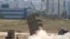 FILE - A missile is launched by an "Iron Dome" battery in Ashdod, Israel, July 11, 2014. Israel is looking to boost the amount of money the United States sends it every year for military aid to as much as $5 billion.