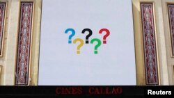Question marks in the arrangement of Olympic rings are pictured on a screen at Madrid's landmark Callao Square, Sept. 6, 2013.
