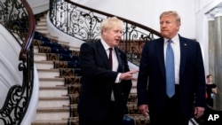 President Donald Trump and Britain's Prime Minister Boris Johnson, left, speak to the media before a working breakfast meeting at the Hotel du Palais on the sidelines of the G-7 summit in Biarritz, France, Aug. 25, 2019.
