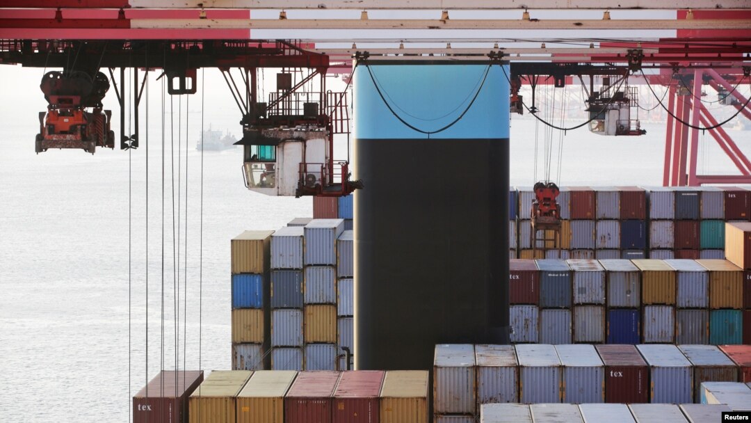 FILE - Containers are seen unloaded from the Maersk's Triple-E giant container ship Maersk Majestic, one of the world's largest container ships, at the Yangshan Deep Water Port, part of the Shanghai Free Trade Zone, in Shanghai, China, Sept. 24, 2016. 