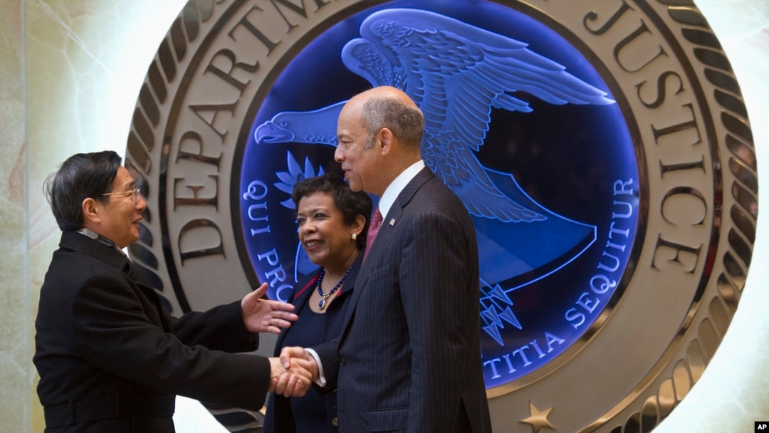 Attorney General Loretta Lynch, center, and Homeland Security Secretary Jeh Johnson, right, welcome Chinese Minister of Public Security Guo Shengkun to the Justice Department in Washington, Tuesday, Dec. 1, 2015.
