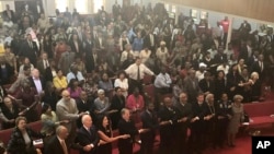 Presidential candidate and former Vice President Joe Biden, left front, joins the congregation of 16th Street Baptist Church in Birmingham, Alabama, as they sing “We Shall Overcome” at Sunday worship on Sept. 15, 2019. 
