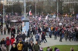 Belarusian opposition supporters walk during a rally to reject the presidential election results in Minsk, Belarus, Nov. 1, 2020.