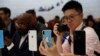 FILE - A demonstration of the newly released Apple products is seen following the product launch event at the Steve Jobs Theater in Cupertino, California, Sept. 12, 2018.