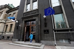 A woman leaves Estonia's central bank in Tallinn, Estonia, March 25, 2019.
