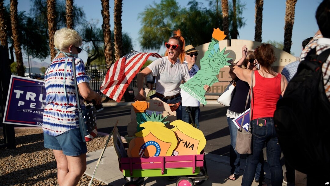 FILE - People protest, Aug. 4, 2020, in Las Vegas against a law signed this week by Nevada Gov. Steve Sisolak to mail ballots to all of the state's active voters ahead of the November election. 