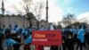 A protester from the Uyghur community living in Turkey holds an anti-China placard during a protest against the visit of China's Foreign Minister Wang Yi to Turkey, in Istanbul, March 25, 2021. 