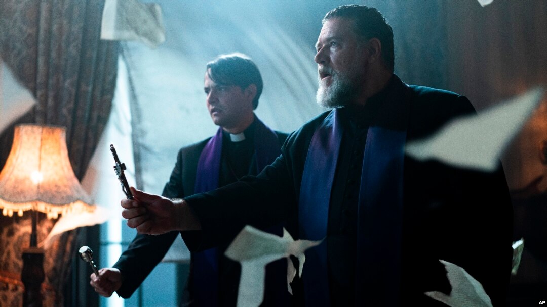 This image released by Sony Pictures shows Daniel Zovatto, left, and Russell Crowe in a scene from Screen Gems' "The Pope's Exorcist."