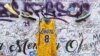 Sneakers and a Los Angeles Lakers jersey with the number 8 worn by NBA star Kobe Bryant hang at a memorial for Bryant in Los Angeles, Feb. 2, 2020, a week after he was killed in a helicopter crash. 