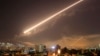 Damascus skies erupt with surface to air missile fire as the U.S. launches an attack on Syria targeting different parts of the Syrian capital Damascus, Syria, early Saturday, April 14, 2018.