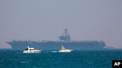 FILE - The United States' Navy USS George H.W. Bush aircraft carrier is seen docked in the Mediterranean Sea off the coast of Haifa, Israel, July 1, 2017. The U.S.-led anti-IS military coalition said Wednesday it conducted no airstrikes in Syria between May 5 and June 3.