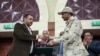 Gen. Mohammed Hamdan Dagalo, right, and Sudan's pro-democracy movement leader Ahmad al-Rabiah shake hands after signing a power sharing document in Khartoum, Sudan, Wednesday, July 17, 2019. The two sides are still at work on a more contentious…