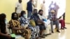FILE - People wait after receiving the AstraZeneca's COVID-19 vaccine at the National Hospital in Abuja, Nigeria, March 31, 2021.