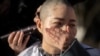 Li Wenzu has her head shaved to protest the detention of her husband and Chinese human rights lawyer Wang Quanzhang, detained during the 709 crackdown, in Beijing on Dec. 17, 2018.