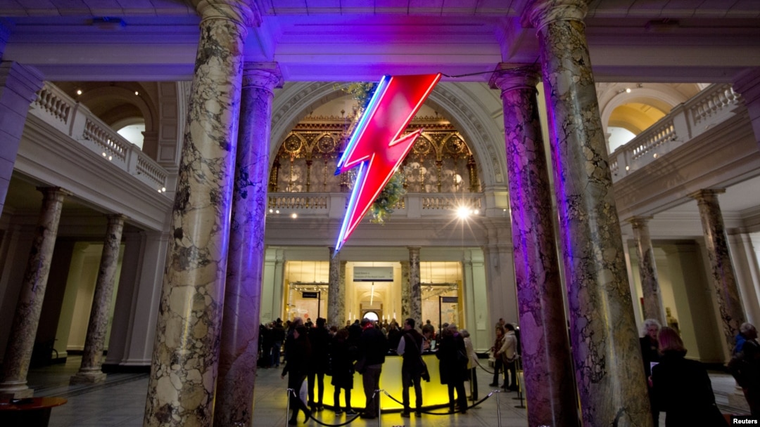 A neon flash representing David Bowie's "Aladdin Sane" stage character is seen at the entrance to the Victoria and Albert Museum to mark the "David Bowie is" exhibition in London, March 20, 2013. 