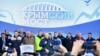 Russian President Vladimir Putin, center, speaks to workers after riding a train across a bridge linking Russia and the Crimean peninsula in Taman, Russia, Dec. 23, 2019.