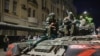 FILE - Members of the Wagner Group military company sit atop a tank on a street in Rostov-on-Don, Russia, June 24, 2023.