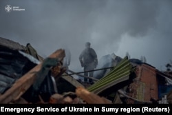 Firefighters work at the site of a Russian military strike, amid Russia's attack on Ukraine, in Sumy, Ukraine November 26, 2024. (Press service of the State Emergency Service of Ukraine in Sumy region/Handout via Reuters)