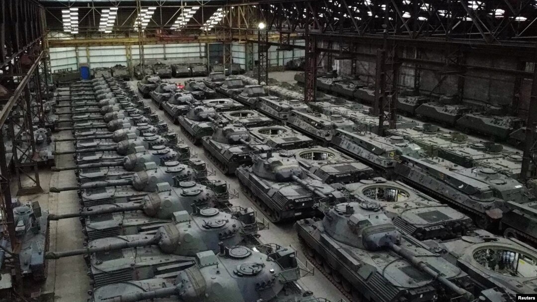 Dozens of German-made Leopard 1 tanks and other armoured vehicles are seen in an hangar in Tournais.
