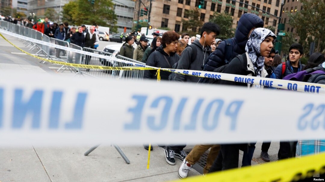 Students walk past police line tape on their way to school a day after a man driving a rented pickup truck mowed down pedestrians and cyclists on a bike path alongside the Hudson River in New York City, New York, Nov. 1, 2017.