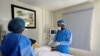 FILE - Doctor Oluwajoba Oroge attends to a patient at EHA Clinics in Abuja, Nigeria, Jan. 14, 2021. Picture taken, Jan, 14, 2021. 