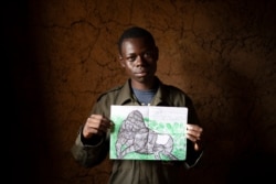Jean Claude Masengesho holds one of his many drawings of silverback gorillas in Kinigi, Rwanda, Sept. 5, 2019.