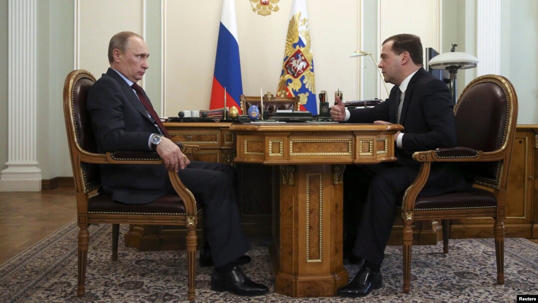 Russian President Vladimir Putin (L) meets with Prime Minister Dmitry Medvedev at the Novo-Ogaryovo state residence outside Moscow, March 27, 2014.
