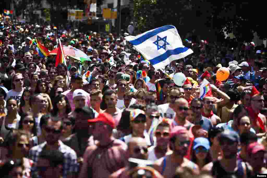 People take part at the annual Gay Pride parade in Tel Aviv. Thousands of revelers paraded on the streets of Israel's free-wheeling city, which has become a Mediterranean hotspot for gay tourism.