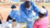 FILE - A Congolese health worker administers Ebola vaccine to a woman who had contact with an Ebola sufferer in the Democratic Republic of Congo, Aug. 18, 2018. 