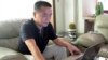 FILE - Veteran rights activist Huang Qi works on his laptop in his home in Chengdu in southwestern China's Sichuan province, Sept. 18, 2012.