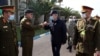 FILE - Turkey's Defense Minister Hulusi Akar, center, and other top Turkish military commanders, rear, greet Libyan commanders, in Tripoli, Libya, Dec. 26, 2020.