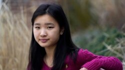 High school student Grace Hu, 16, sits for a photograph near Sharon High School, Sunday, April 11, 2021, in Sharon, MA.