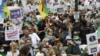 People attend a demonstration in Paris on July 5, 2020 in support of Algeria's Hirak key protest movement as Algeria celebrates today the anniversary of its 1962 independence from France.