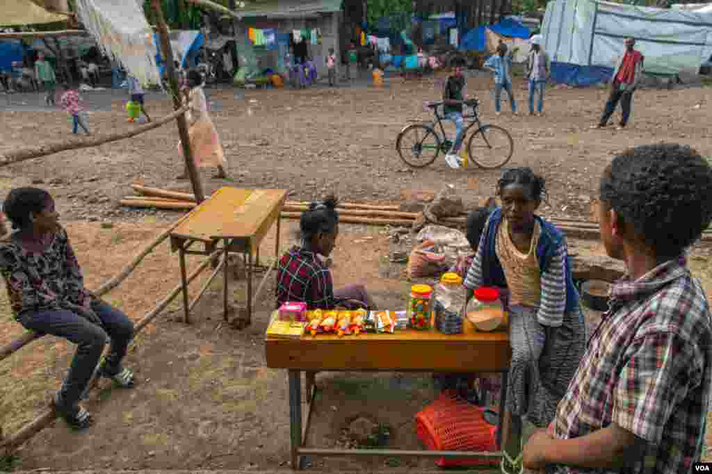 Children sell candies and biscuits in the displacement camp where they are living in Shire, June 11, 2021. (Yan Boechat/VOA) 