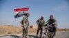 Syrian government forces man a checkpoint near the town of Tal Tamr, north Syria, Oct. 22, 2019. 