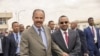 FILE - Eritrean President Isaias Afwerki, left, and Ethiopian Prime Minister Abiy Ahmed walk together at Asmara International Airport, Eritrea, July 9, 2018.