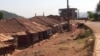 Clothes hang on a clothes line in front of a row of largely abandoned homes, in Kumbo, Cameroon, Jan. 3, 2019. (M. E. Kindzeka/VOA)