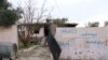 The word "Daeshy," meaning IS militant, is scrawled on a burnt-out house once belonging to a militant in a village outside of Mosul city in Iraq, Nov. 27, 2018.