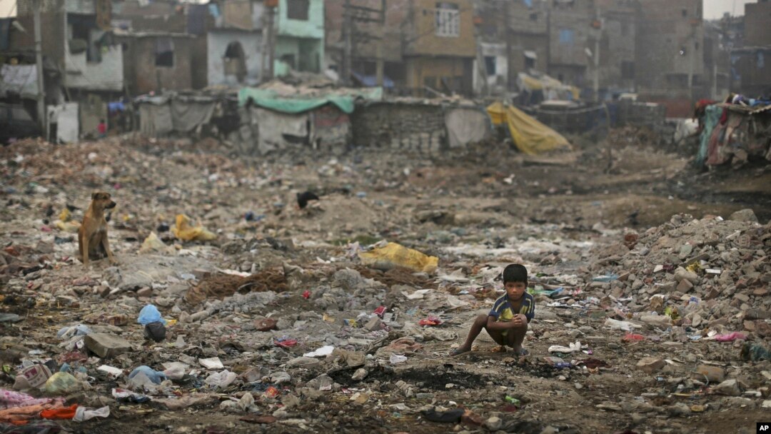FILE- An Indian boy defecates in the open in a poor neighborhood of New Delhi, India, Nov. 6, 2012.