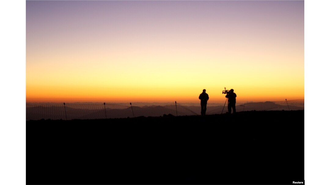 Members of the media work during the opening ceremony of the construction of The Giant Magellan Telescope (GMT) at Las Campanas hill near Vallenar town, Chile, Nov. 11, 2015.