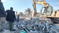Members of Iraqi Shiite Popular Mobilization Forces clean the rubble after a U.S. airstrike in al-Qaim, Iraq, Feb. 3, 2024. The U.S. Central Command said in a statement on Friday that the U.S. forces conducted airstrikes on more than 85 targets. 