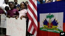 En esta foto de archivo, niños sostiene un cartel con una leyenda en apoyo al TPS para Haití y países centroamericanos el 6 de noviembre de 2017 en Miami.