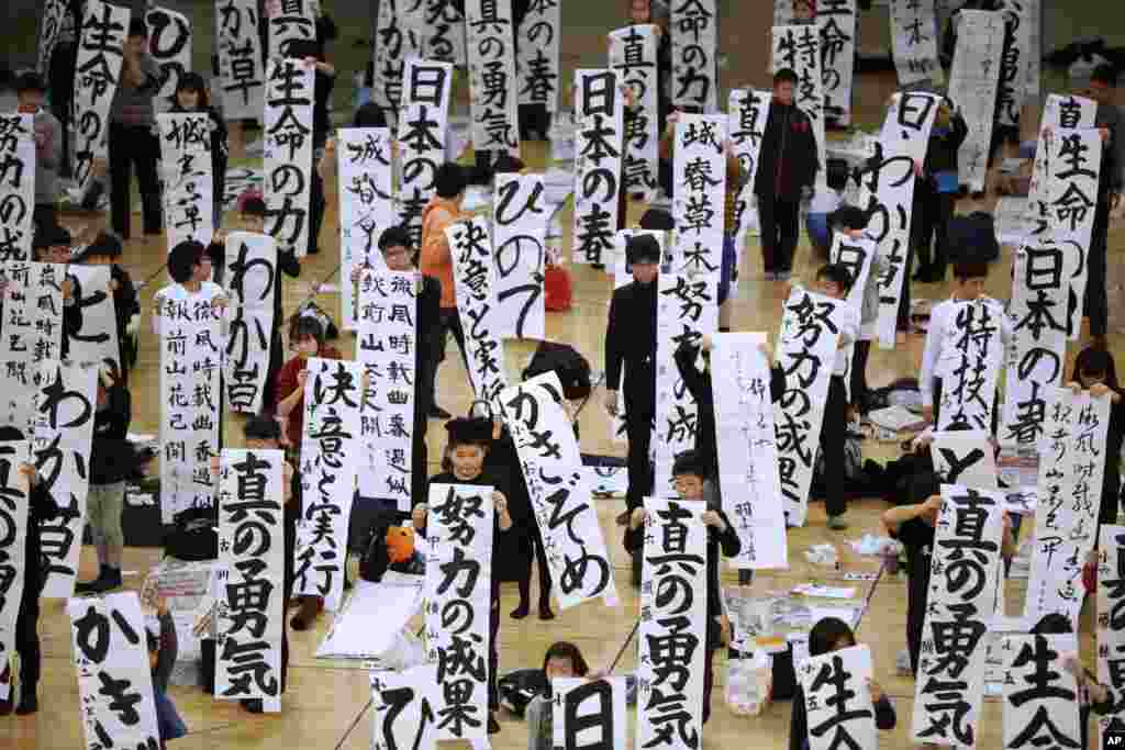 Participants show off their traditional Japanese calligraphy works during the annual New Year&#39;s calligraphy contest at the Budokan martial arts hall in Tokyo, Japan, Jan. 5, 2017.