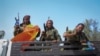 FILE - Tigray forces travel in a truck after taking control of Mekele, in the northern regino of Tigray, Ethiopia, June 29, 2021. 