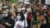 Chinese demonstrators shout slogans during a protest against a planned refinery project in downtown Kunming in southwest China's Yunnan province, May 16, 2013. 