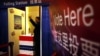 A guest at a event organized by the U.S. embassy casts his vote for either President Barack Obama or Republican presidential nominee Mitt Romney at an imitation polling booth in Beijing, Nov. 7, 2012. 